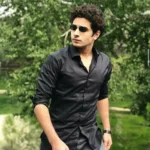 A man wearing sunglasses and a black shirt, featured in a review image